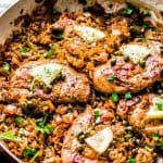Chicken Piccata and Rice set on a wooden table next to a dish towel