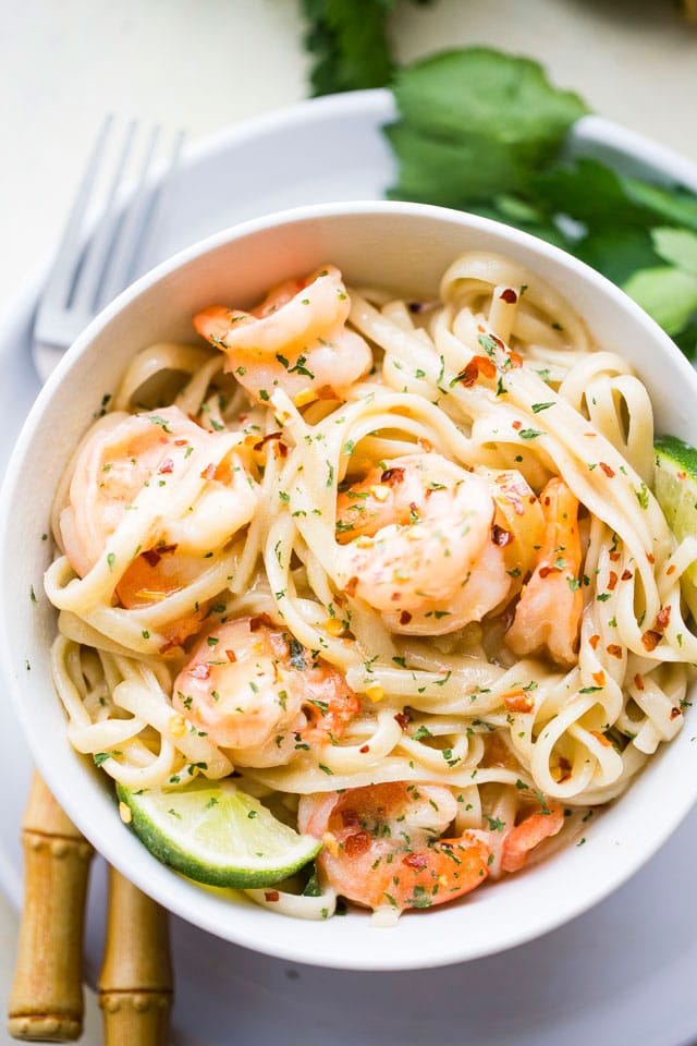 Coconut Lime Shrimp served over noodles in a white bowl