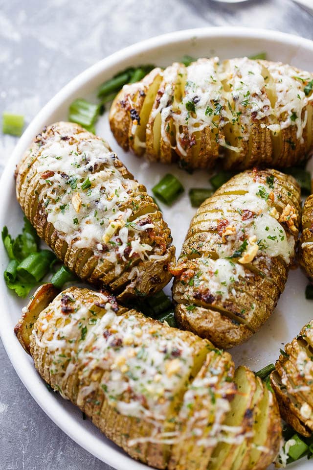 Garlic Butter Hasselback Potatoes - Perfectly tender hasselback potatoes prepared with delicious garlic butter and a sprinkle of cheese.