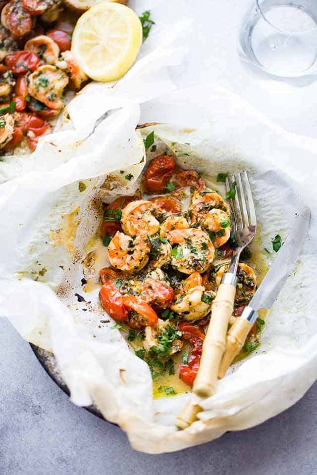 Lemon Garlic Herb Shrimp in Packets, with a knife and fork set next to the food.