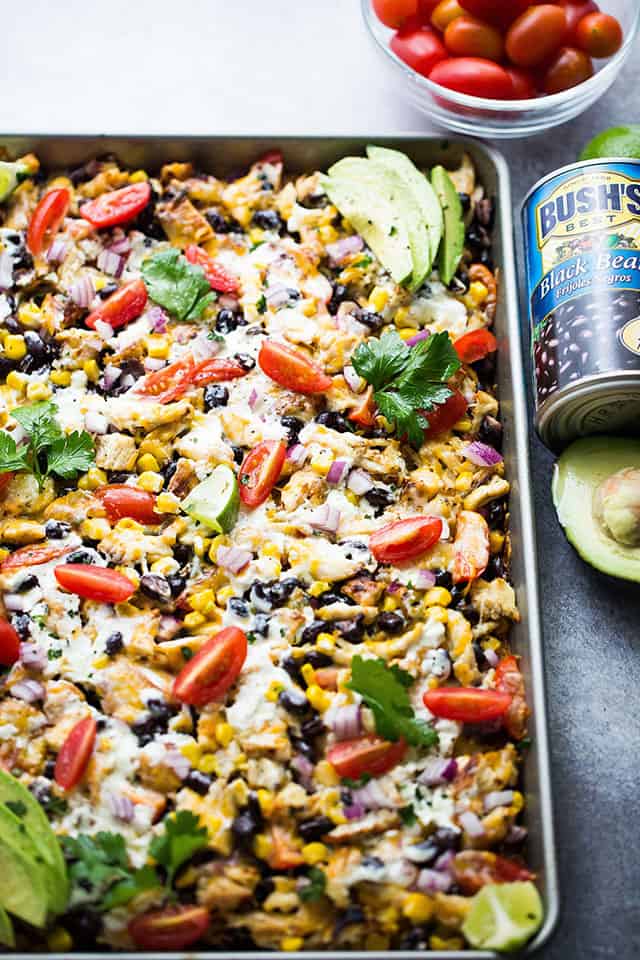 Sheet Pan Lime Chicken Nachos - Easy to make, fun, delicious nachos baked on a sheet pan and loaded with beans, corn, lime chicken, and cheese! Perfect for entertaining a crowd!