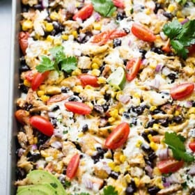 Sheet Pan Lime Chicken Nachos - Easy to make, fun, delicious nachos baked on a sheet pan and loaded with beans, corn, lime chicken, and cheese! Perfect for entertaining a crowd!
