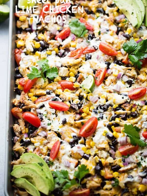 Sheet Pan Lime Chicken Nachos - Easy to make, fun, delicious nachos baked on a sheet pan and loaded with beans, corn, lime chicken, and cheese! Perfect for entertaining a crowd!