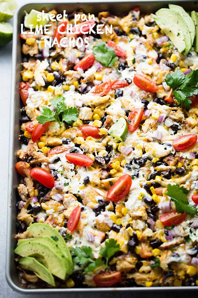 Sheet Pan Lime Chicken Nachos - Easy to make, fun, delicious nachos baked on a sheet pan and loaded with beans, corn, lime chicken, and cheese! Perfect for entertaining a crowd!