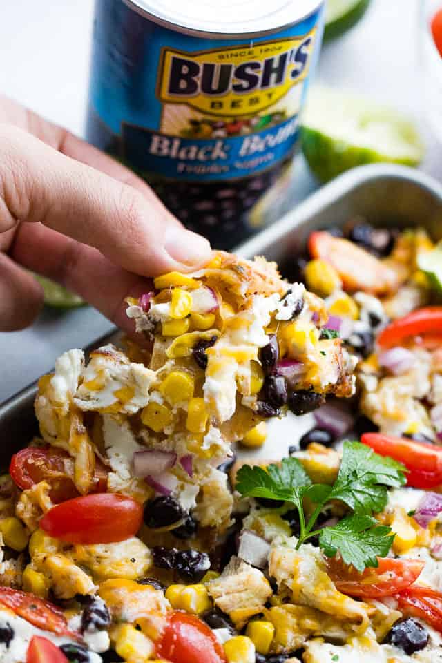 Sheet Pan Lime Chicken Nachos - Easy to make, fun, delicious nachos baked on a sheet pan and loaded with beans, corn, lime chicken, and cheese! Perfect for entertaining a crowd!