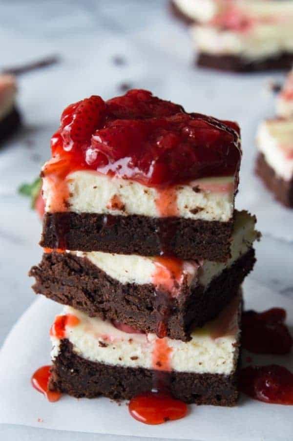 A stack of Strawberry Cheesecake Brownies on a plate