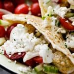 Close up of a pita pocket filled with turkey meatballs, salad, and feta.