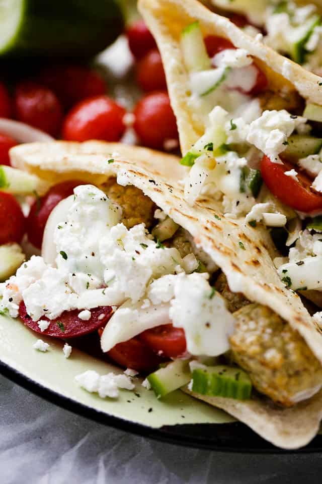 Turkey Meatballs Pita Pockets with Cucumber Yogurt Sauce - Juicy and delicious turkey meatballs served in warm pita pockets filled with a garlicky cucumber sauce and topped with a tomatoes and feta cheese salad.