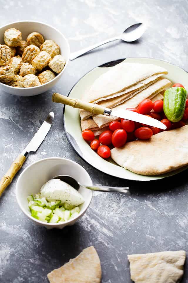 Turkey Meatballs Pita Pockets with Cucumber Yogurt Sauce - Juicy and delicious turkey meatballs served in warm pita pockets filled with a garlicky cucumber sauce and topped with a tomatoes and feta cheese salad.