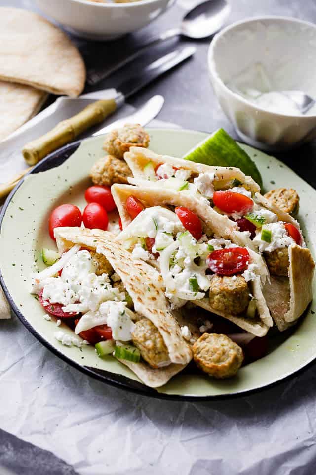 Turkey Meatballs Pita Pockets with Cucumber Yogurt Sauce - Juicy and delicious turkey meatballs served in warm pita pockets filled with a garlicky cucumber sauce and topped with a tomatoes and feta cheese salad.