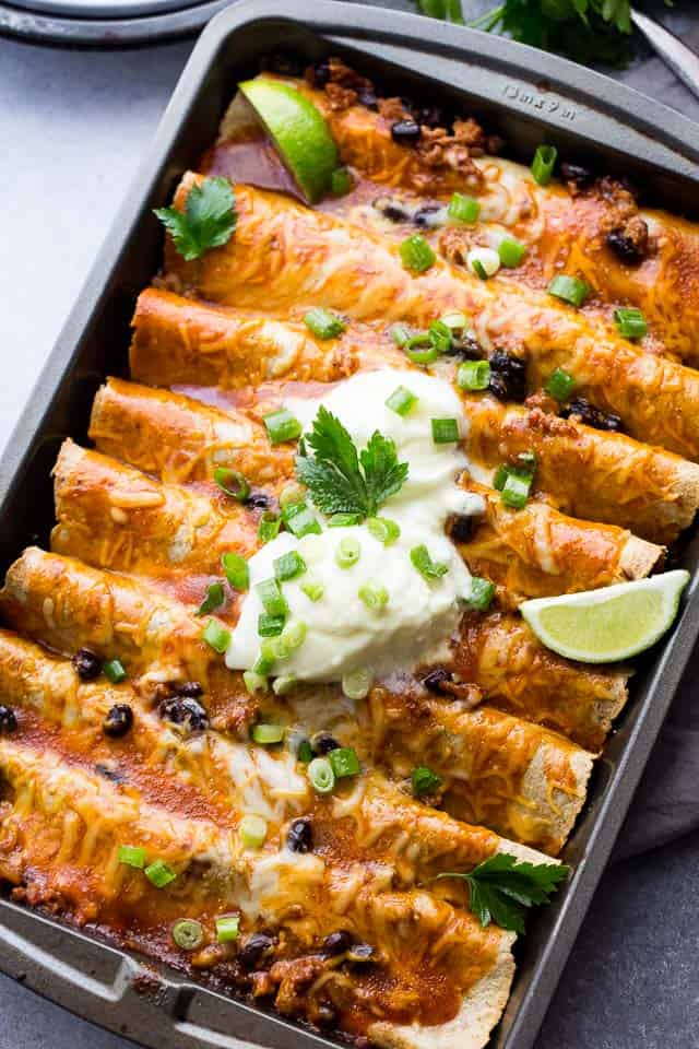 Ground Turkey Black Bean Enchiladas - Loaded with ground turkey and black beans, these saucy, cheesy enchiladas are super easy to make and always everyone's favorite!