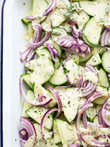 Slices of cucumbers and red onions mixed together.