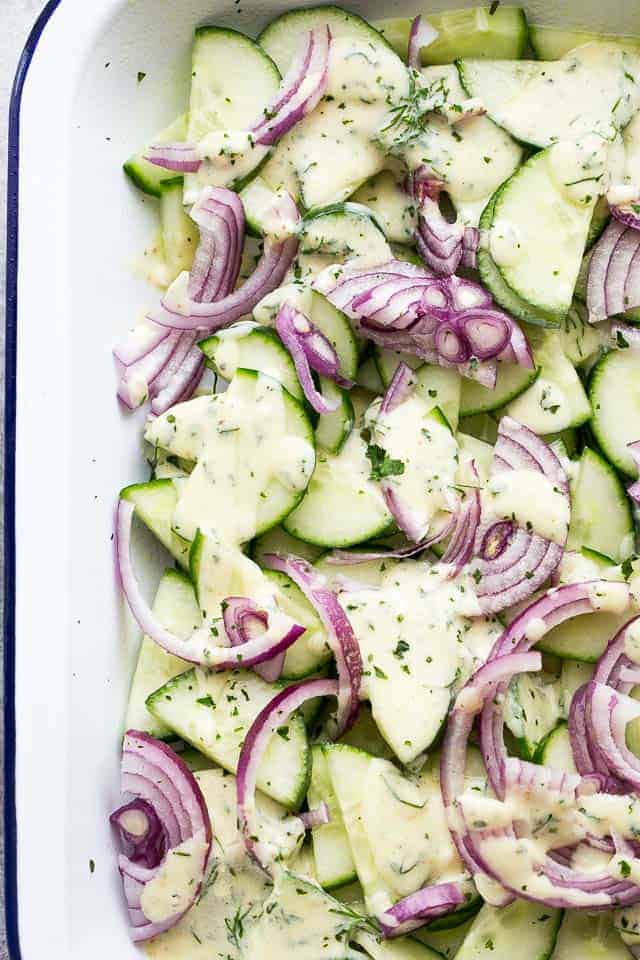 Slices of cucumbers and red onions mixed together.