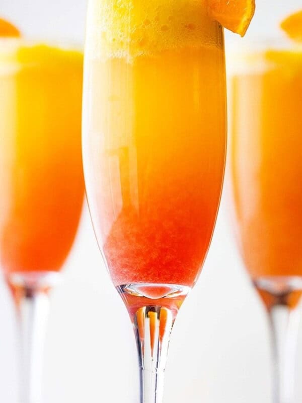 Sunrise Mimosa Recipe - A gorgeous and delicious twist to the classic mimosas prepared with mangos, orange juice, prosecco and liqueur.