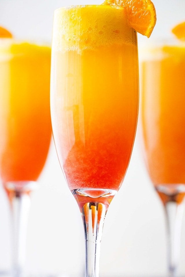 Sunrise Mimosa Recipe - A gorgeous and delicious twist to the classic mimosas prepared with mangos, orange juice, prosecco and liqueur.