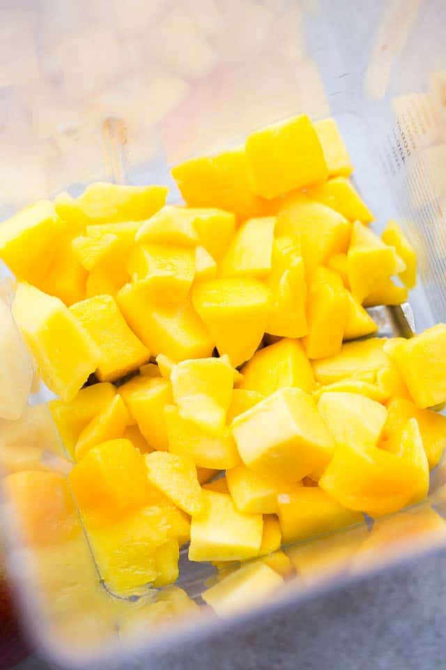 Diced mangoes in a blender.