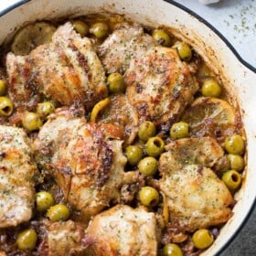 Saucy Skillet Chicken with Lemons and Olives - Delicious pan seared chicken thighs prepared with olives, lemons, and red wine.