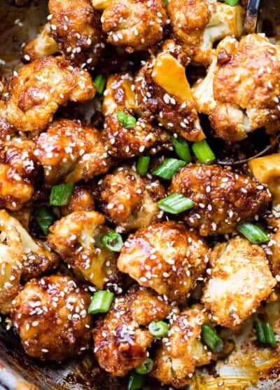 Sticky Sesame Cauliflower Bites - Sweet, spicy, baked cauliflower bites topped with an amazing Asian-inspired sticky sauce! Serve them as finger food appetizers or as the main course over rice for a delicious veggie dinner.
