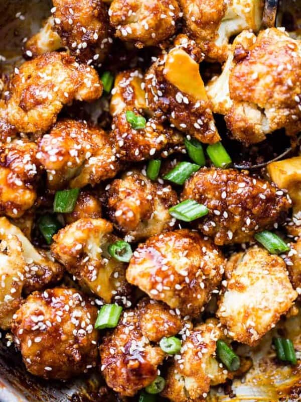 Sticky Sesame Cauliflower Bites - Sweet, spicy, baked cauliflower bites topped with an amazing Asian-inspired sticky sauce! Serve them as finger food appetizers or as the main course over rice for a delicious veggie dinner.