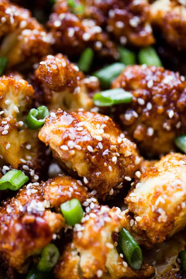 Sticky Sesame Cauliflower Bites - Sweet, spicy, baked cauliflower bites topped with an amazing Asian-inspired sticky sauce! Serve them as finger food appetizers or as the main course over rice for a delicious veggie dinner.