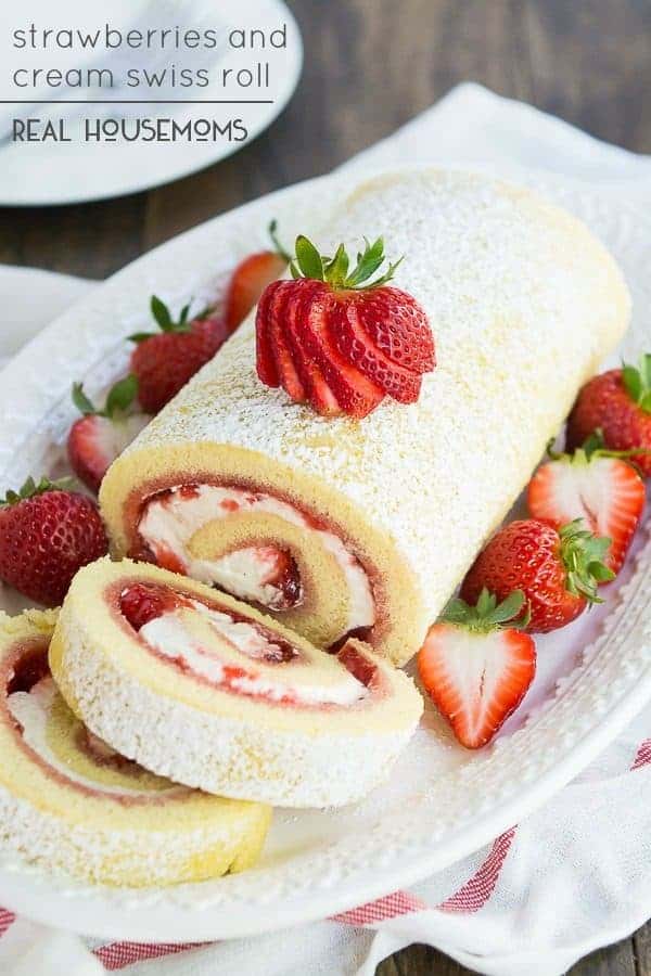 Strawberries and cream swiss roll on a serving platter