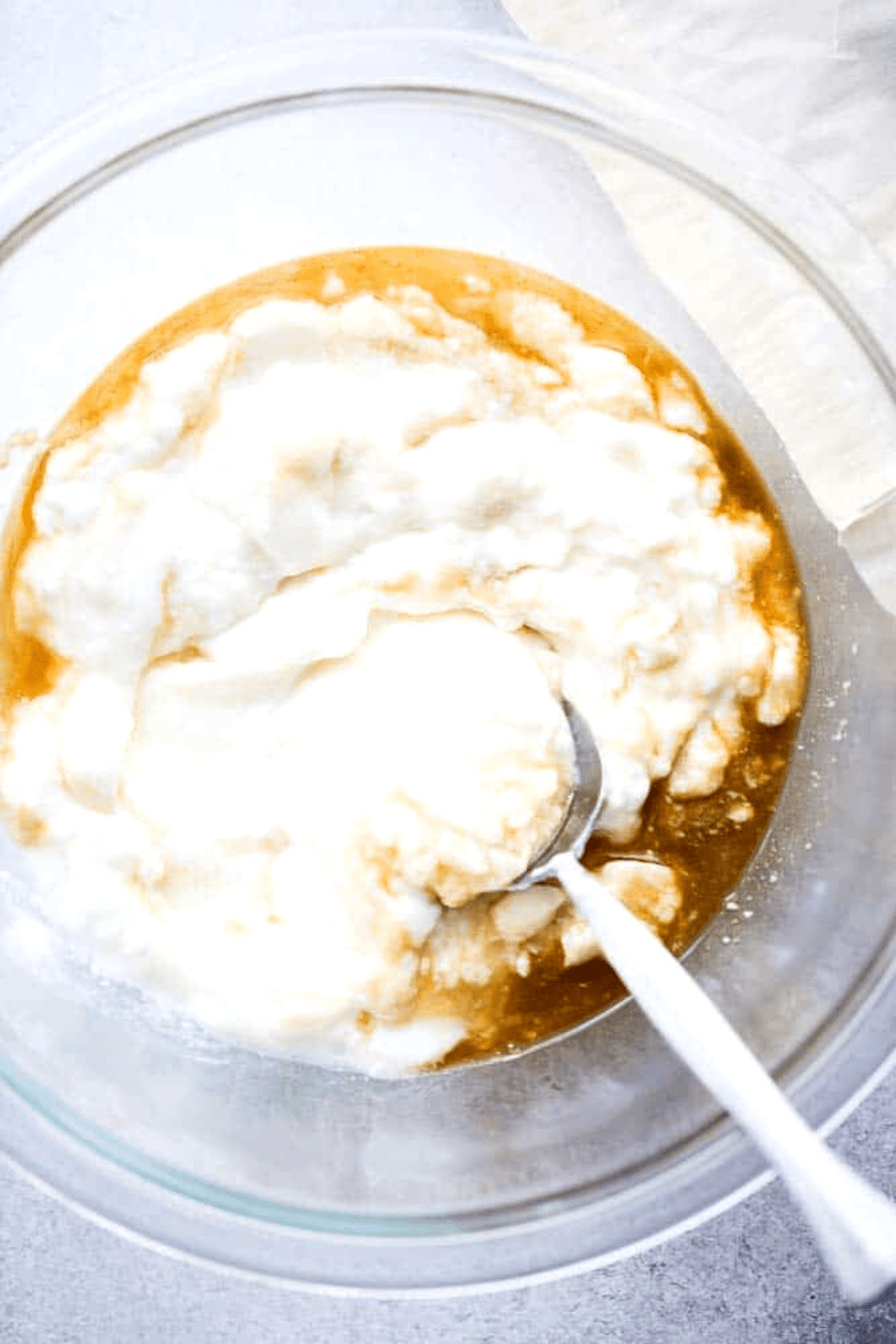 Whisking yogurt and agave in a mixing bowl.