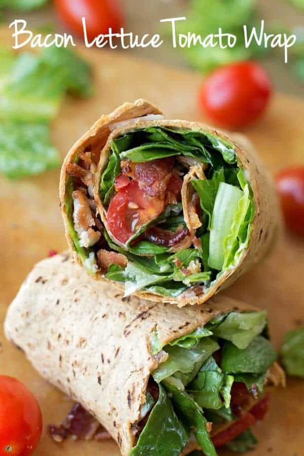 BLT wrap halves stacked on a cutting board