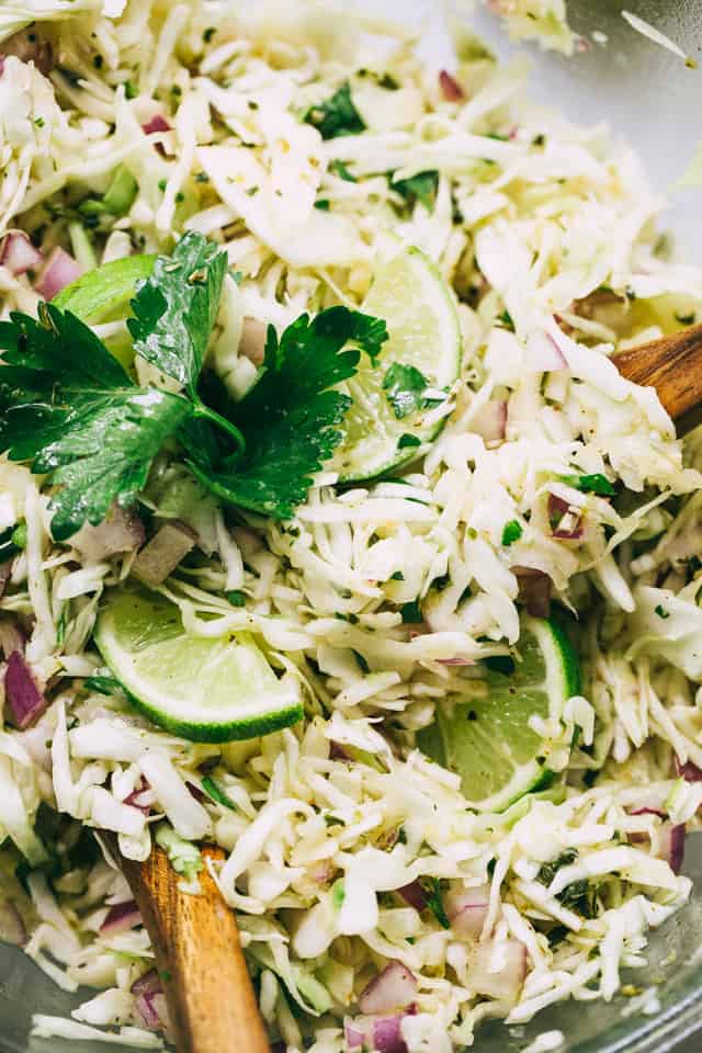 Cilantro Vinaigrette Coleslaw garnished with fresh cilantro leaves in a bowl.