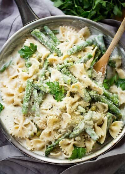 Creamy Vegetable Pasta Recipe - A creamy, yet healthy veggie loaded protein-packed pasta with asparagus and peas, all tossed in a lightened-up cream sauce!