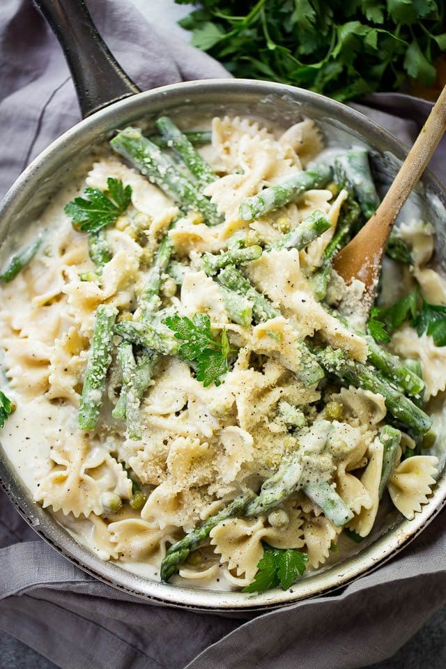 Bow tie pasta with peas and asparagus in a cream sauce.