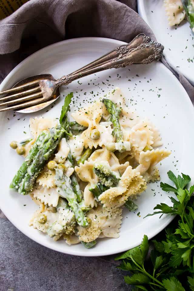 Plate of creamy asparagus pasta with peas.