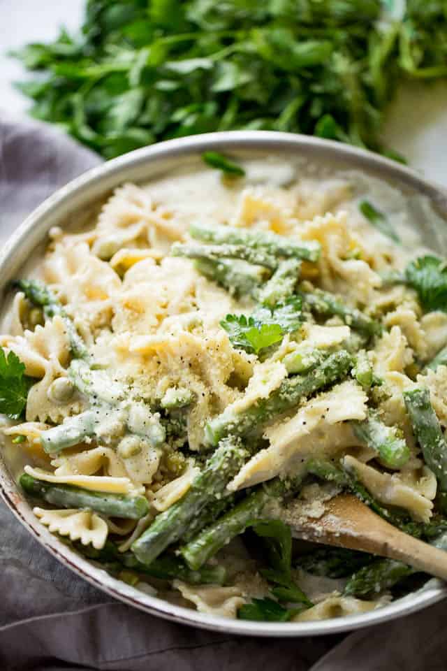 Pot of creamy pasta with asparagus and peas.