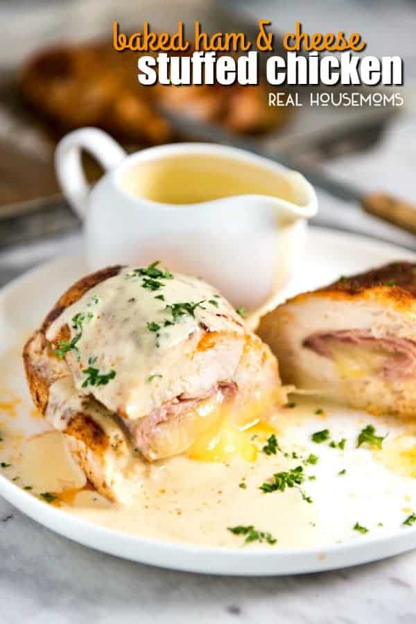 Easy baked ham and cheese stuffed chicken breast cut in half on a plate