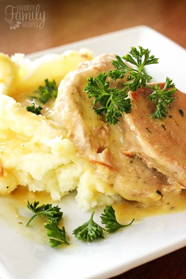 Pork chops with mashed potatoes and fresh herbs on a plate