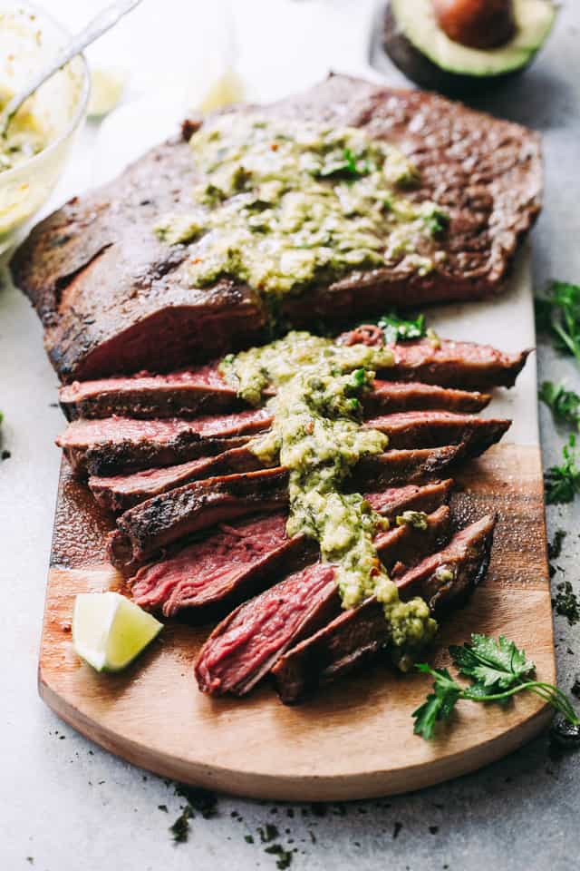 Grilled Flank Steak with Avocado Chimichurri Sauce - Deliciously juicy grilled flank steak served with an amazing blend of avocado and chimichurri sauce!