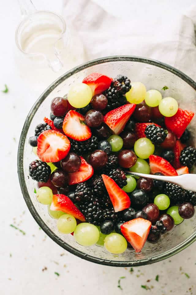 Moscato Fruit Salad - Prepared with colorful grapes and berries, this light, boozy, and delicious fresh fruit salad makes the perfect accompaniment to your summer nights!