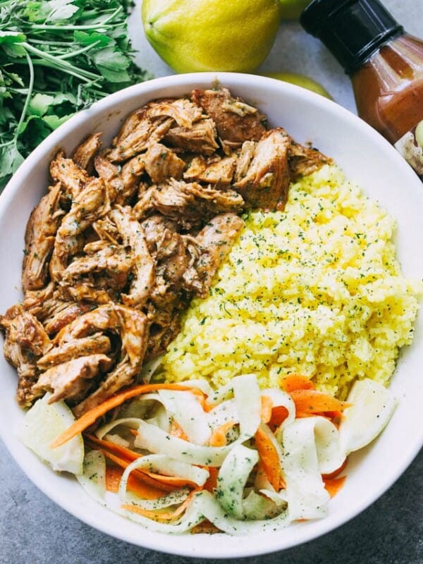Pulled Tandoori Chicken Rice Bowls - Deliciously juicy chicken breasts cooked in tandoori marinade and served over flavorful lemon rice and a cucumber salad.
