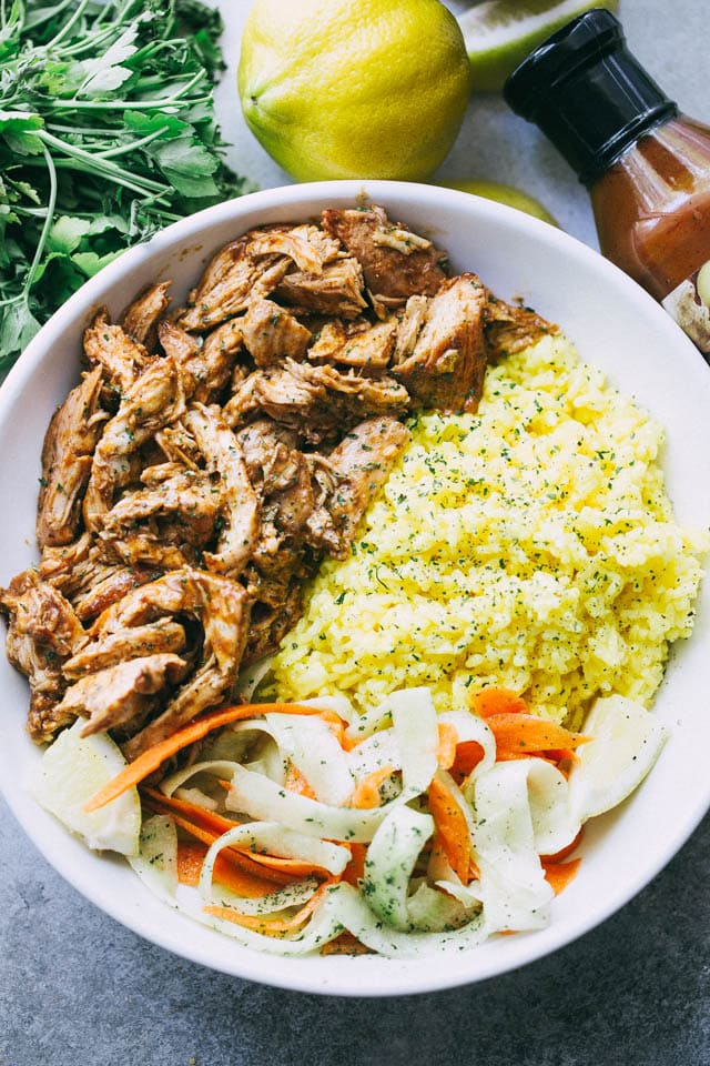 Pulled Tandoori Chicken Rice Bowls - Deliciously juicy chicken breasts cooked in tandoori marinade and served over flavorful lemon rice and a cucumber salad.