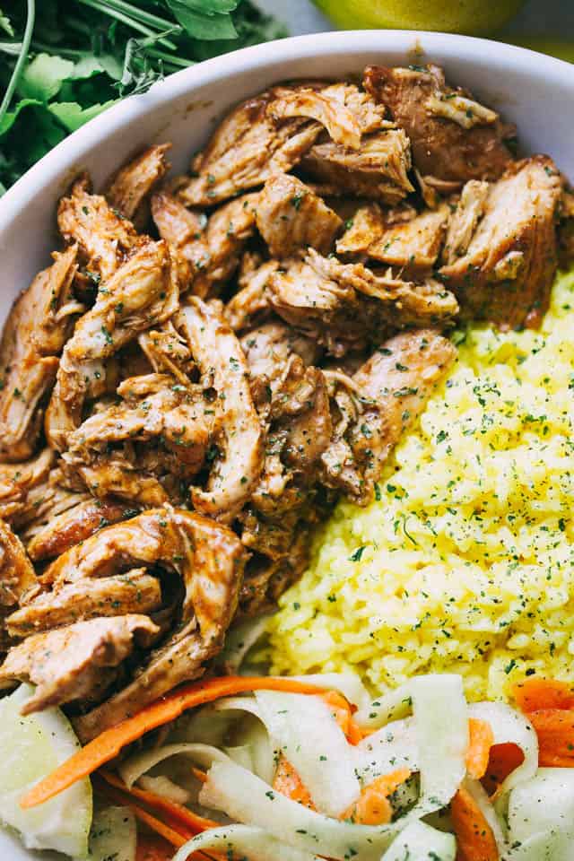 Pulled Tandoori Chicken Rice Bowls - Deliciously juicy chicken breasts cooked in tandoori marinade and served over flavorful lemon rice and a cucumber salad.