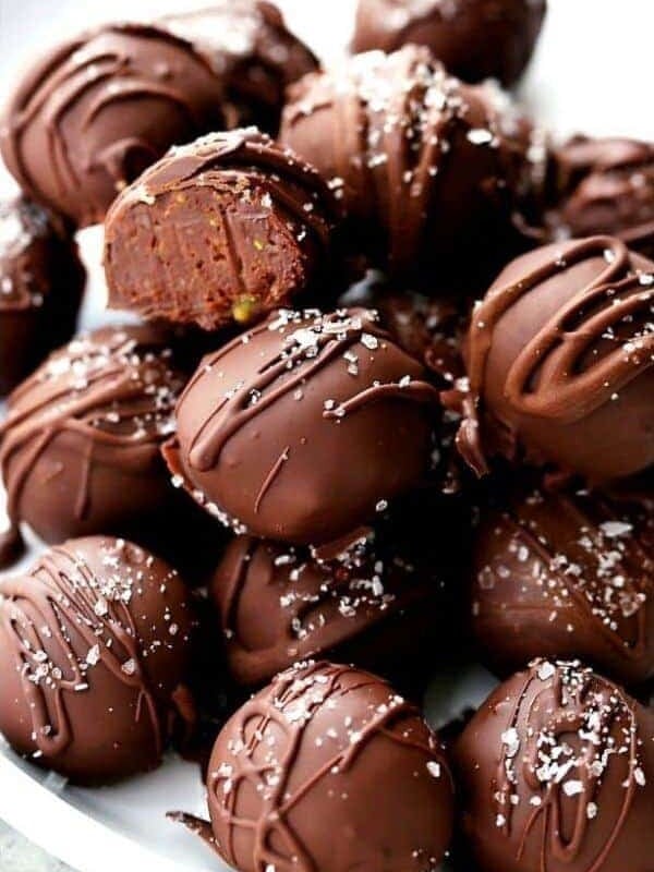 A pile of homemade chocolate truffles served on a plate.