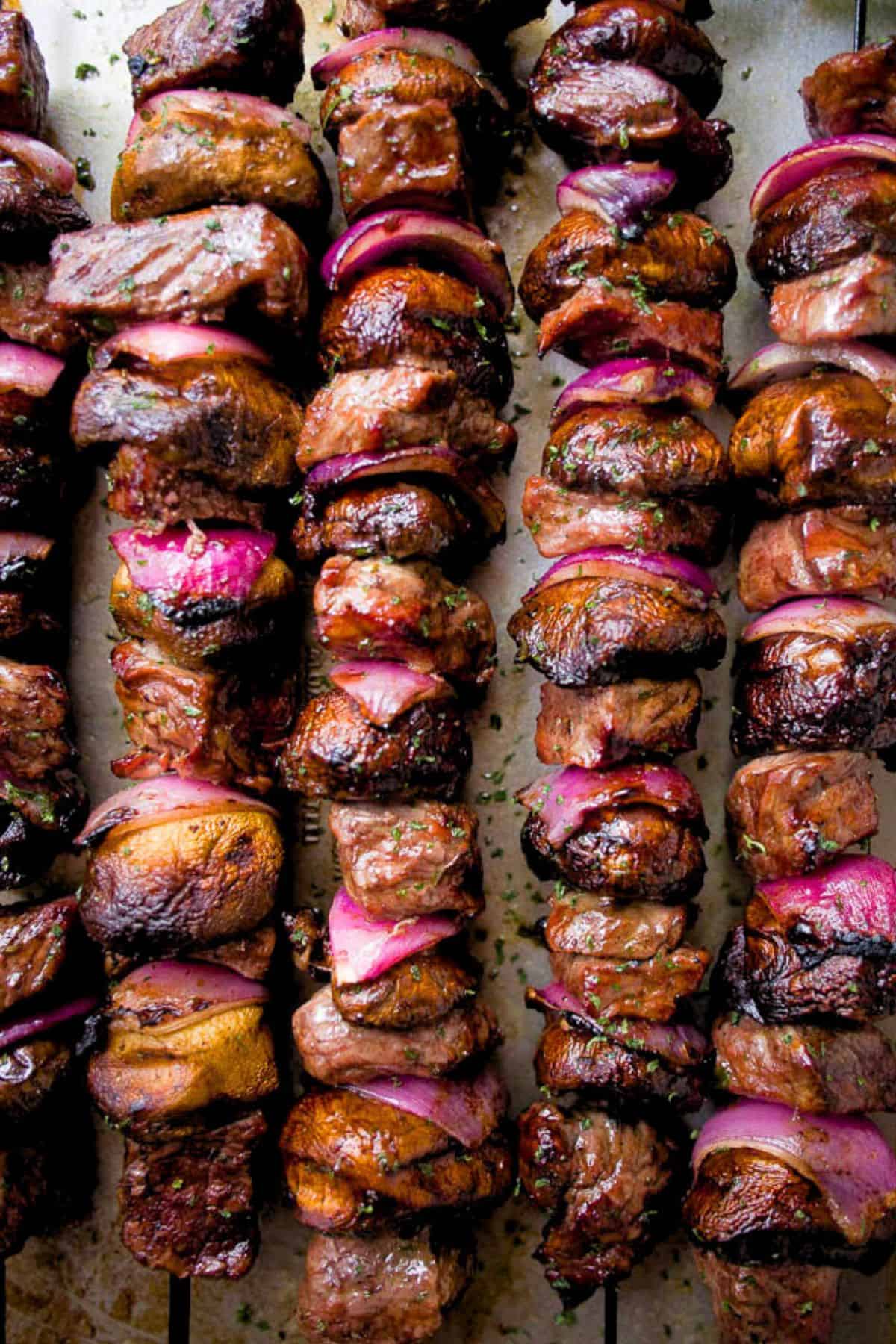 Close-up image of steak kabobs threaded onto skewers.