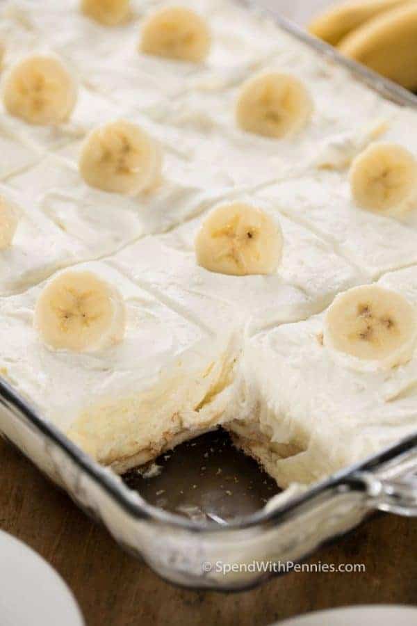 A 9x13 pan of Homemade Banana Pudding cut into squares and garnished with banana coins