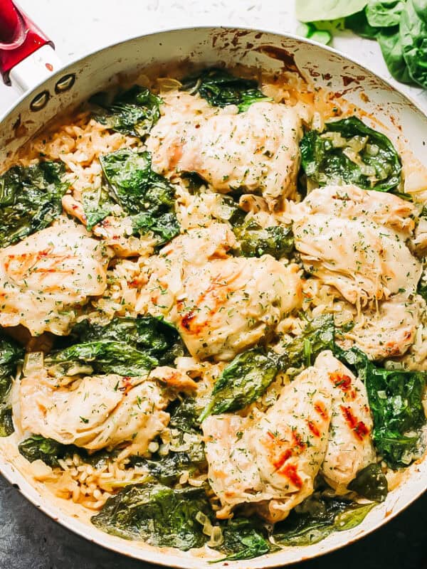 Overhead view of one-pot ranch chicken and rice with fresh spinach.