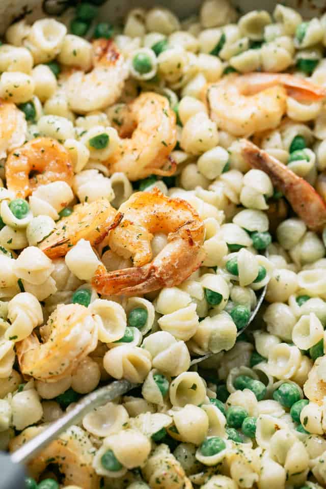 Close-up view of White Cheddar Shells and Cheese with Shrimp and Peas