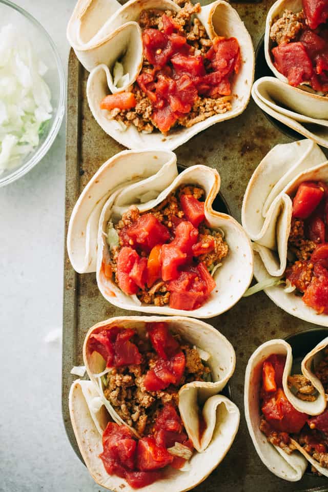 Overhead view of Taco Bowls filled with lettuce, meat and tomatoes