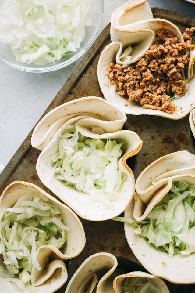 Overhead view of Taco Bowls filled with lettuce