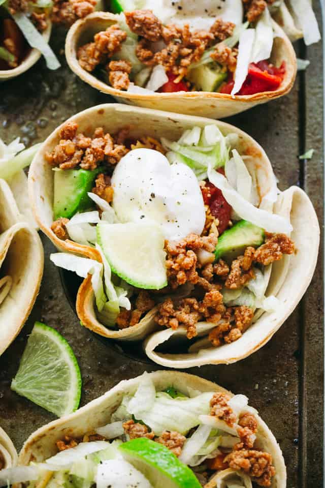 Taco bowls with ground beef mixture stuffed in a bowl made of flour tortillas.