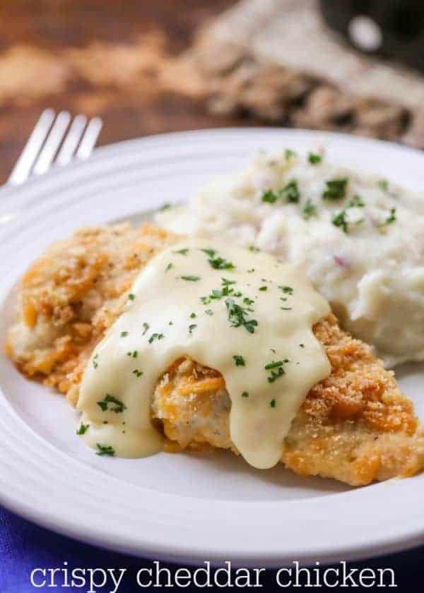 Crispy Cheddar Chicken on a plate with mashed potatoes and gravy