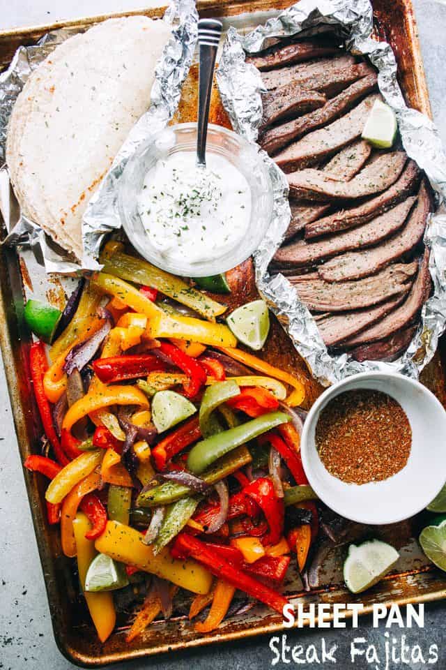 sliced steak, sliced peppers, and flour tortillas in a sheet pan.