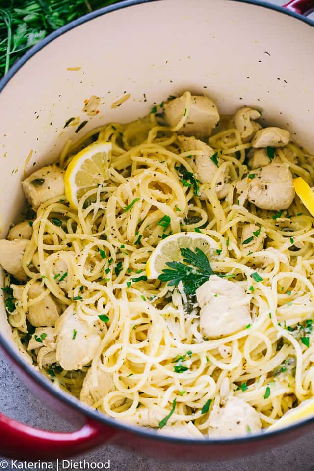 A pot of spaghetti with chicken, lemon, parsley and capers